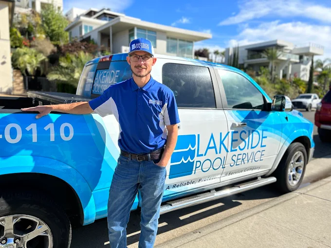 Eric, owner of Lakeside Pool Service, standing beside his branded service truck
